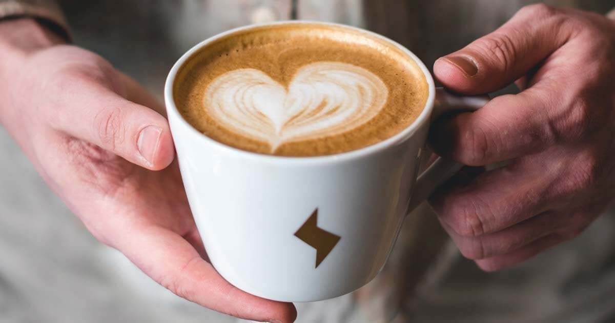 Kaffee-Tasse mit Blitz-Symbol und Herz-Muster als Symbol für hohen Blutdruck